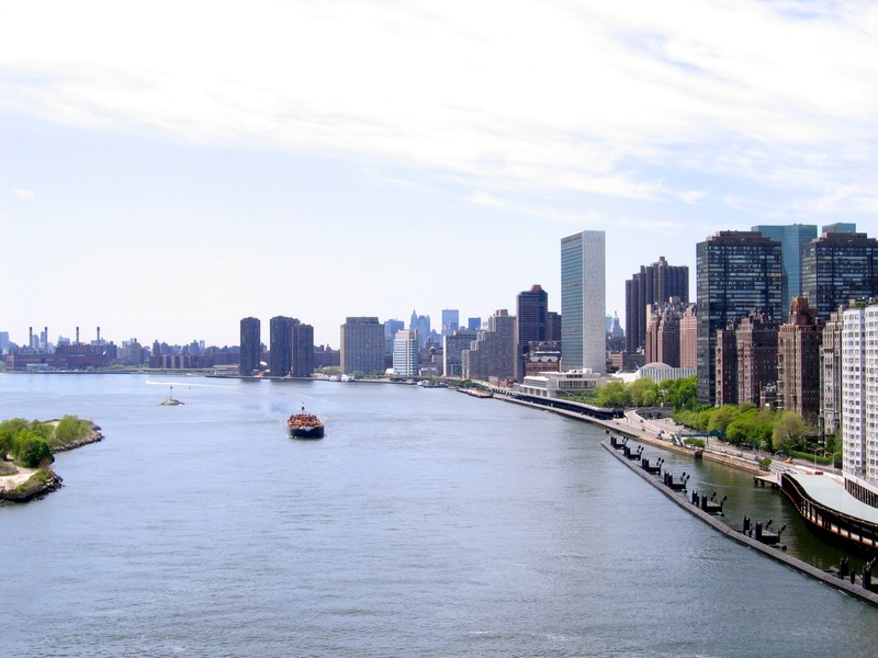 A view to East River from Queensboro Bridge. United Nations building visible at right