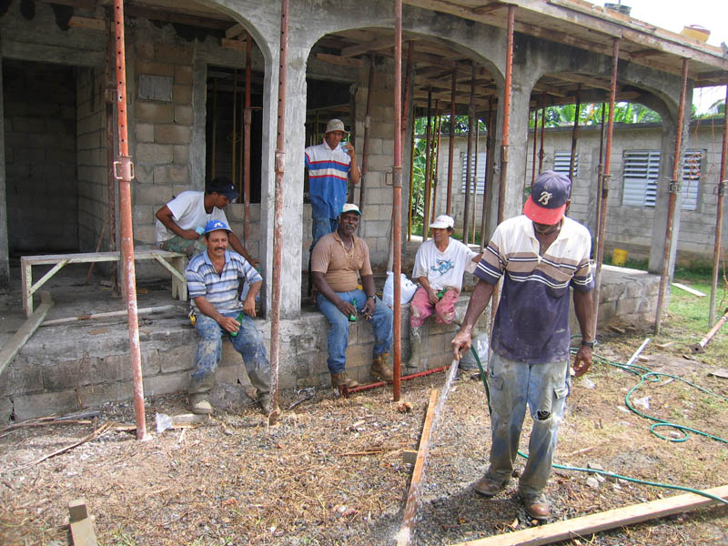 Pablo Brache Castro with his staff resting while waiting for the last load of concrete.