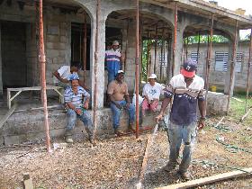 Pablo Brache Castro with his staff resting while waiting for the last load of concrete. (July 2006) Pablo Brache Castro with his staff resting while waiting for the last load of concrete. (July 2006)