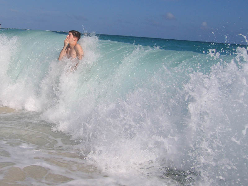 Tom is niether short nor sitting. The wave is realy more than six feet high.