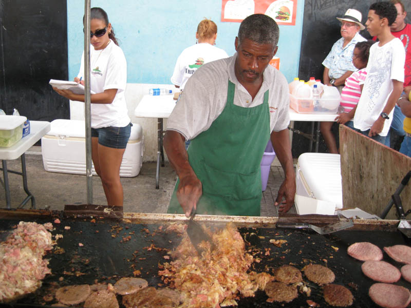 Preparing the famous tripa-burgers in one of the many refreshment stands