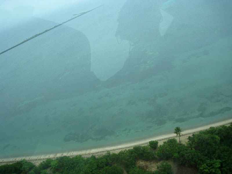 There is everything on this picture: Pilot's reflection, coral reefs, beach, Mosquito Pier,...