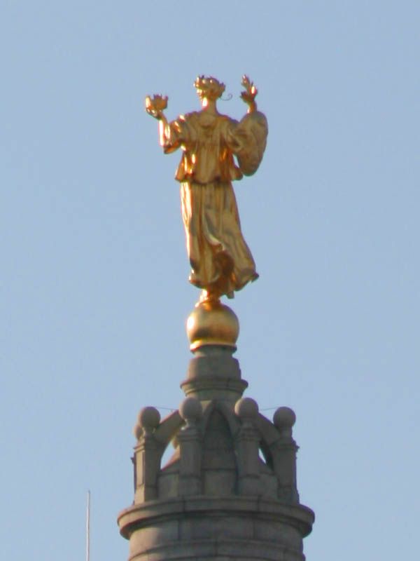 Golden statue high on top of the Manhattan Municipal Building