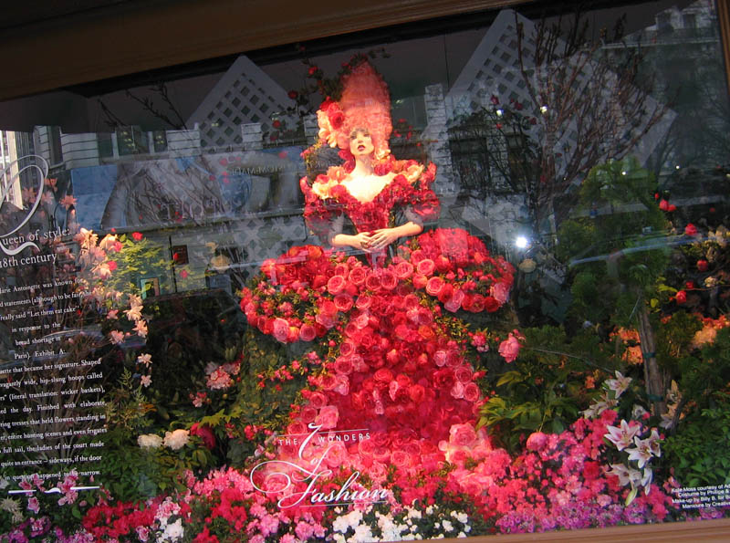 Figurines in displays dressed into flowers