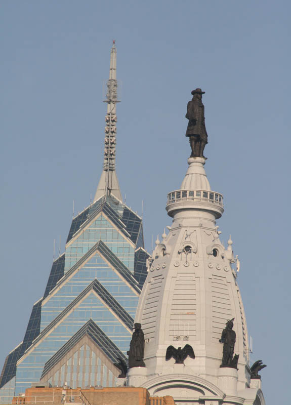 The statue of the city founder William Penn atop Philadelphia City Hall. One Liberty Place building behind it.