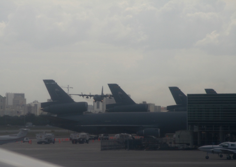 Lockheed C-130 Hercules landing next to the parked KC-10 Extenders