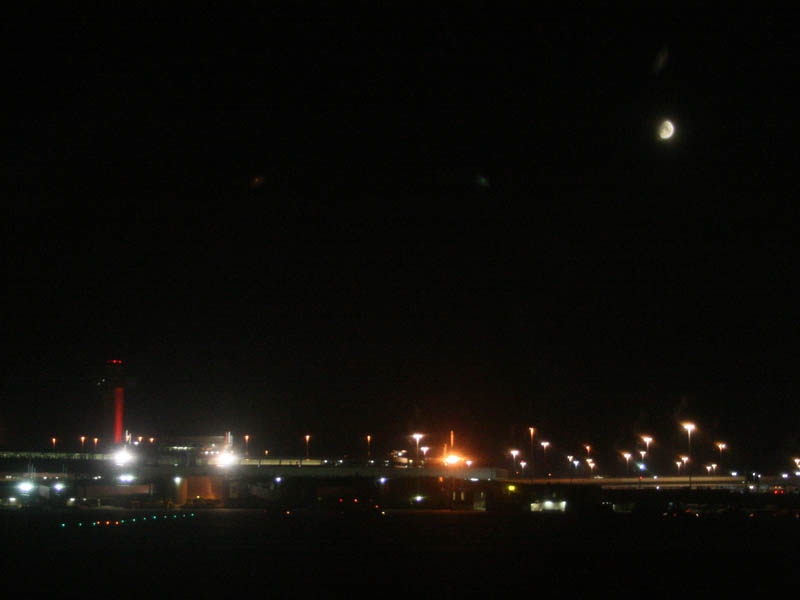 Moon above New York and a color changing control tower