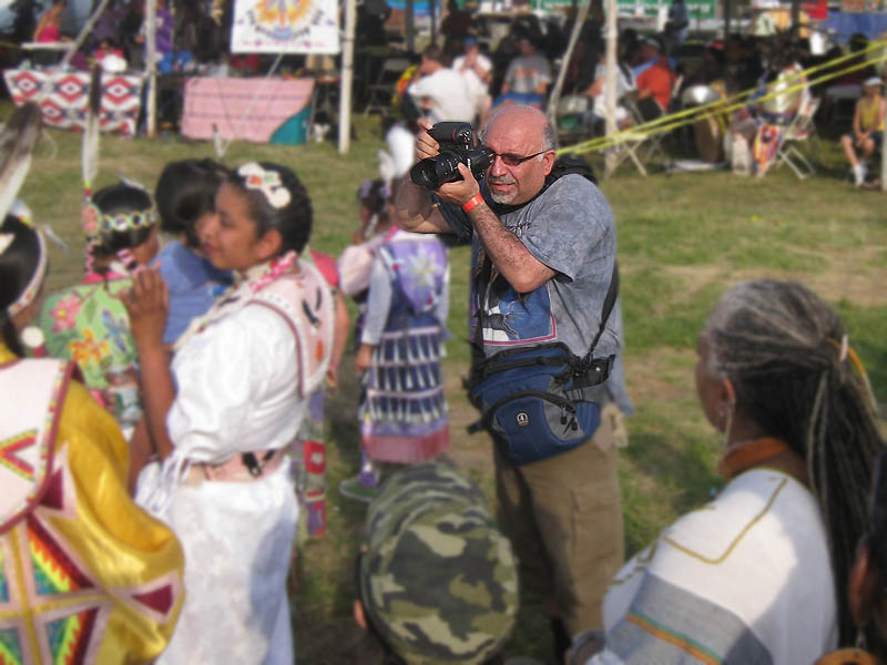 This very rude photographer was taking close pictures even during the prayers, sometimes from a distance of just few inches from the person's face, showing a huge disrespect to them and violating their culture. He harassed them despite turning their faces away expressing clearly their desire not to be photographed.