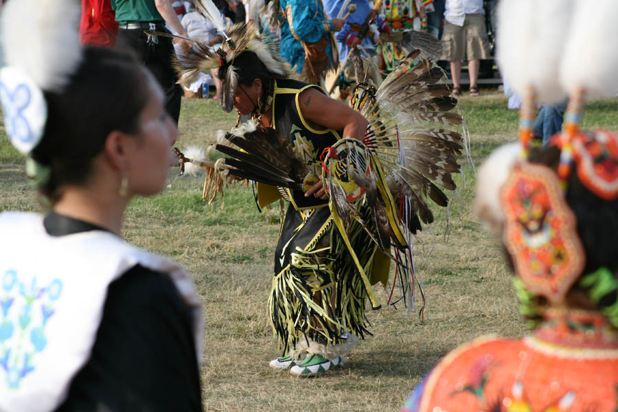 The dancers have their dresses decorated by eagle feathers