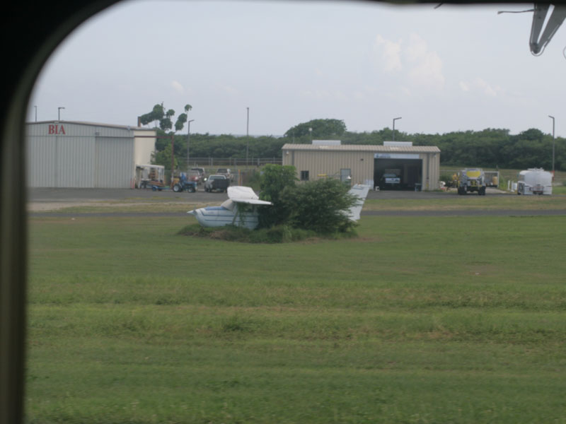 Small airplane "parked" next to runway