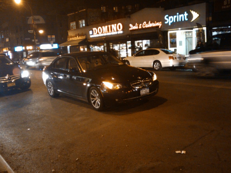 A car perfectly parked in the middle of busy Kings Highway