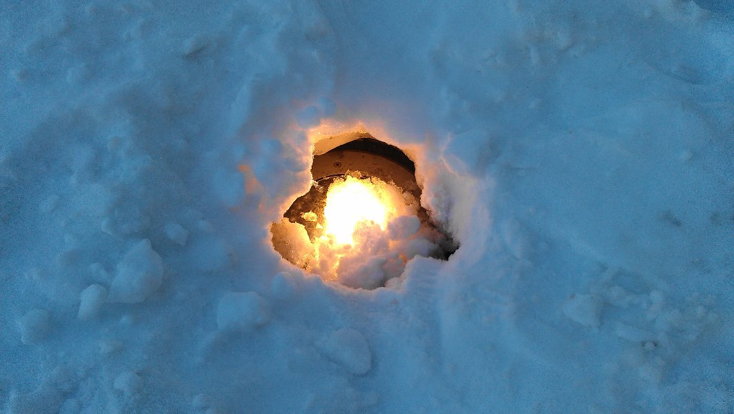 Ground lights on an old square are melting snow