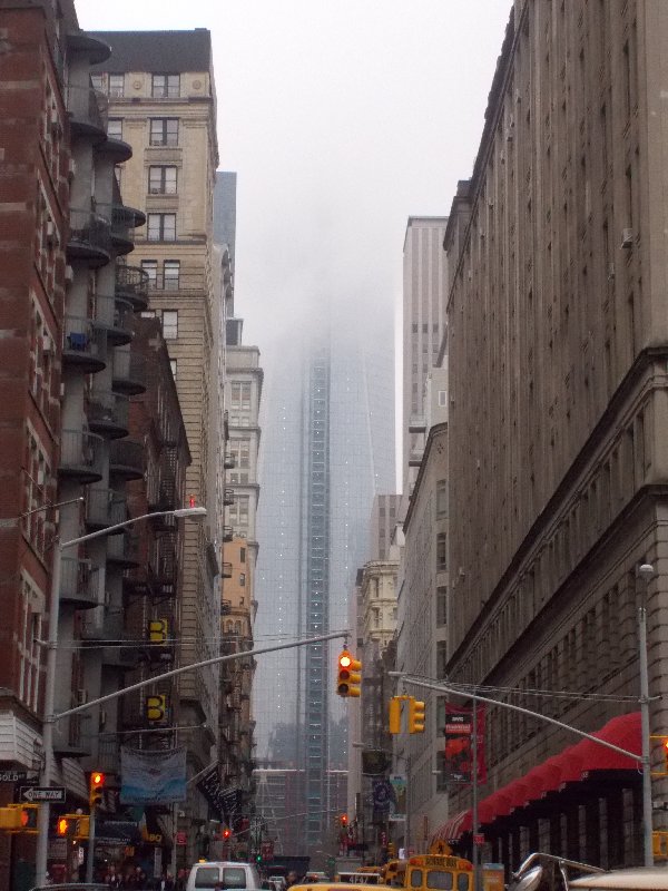 The new, still unfinished Freedom Tower, disappearing in the clouds