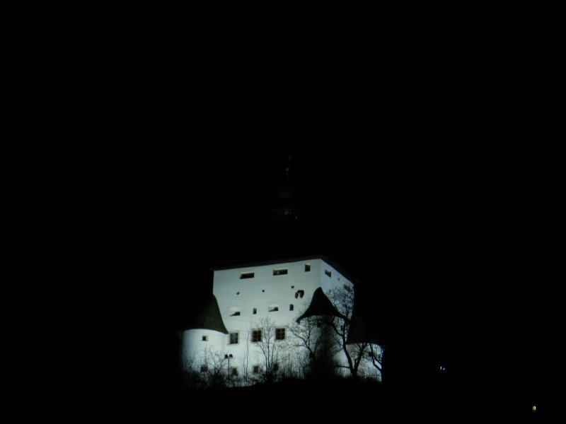 New Castle, lit for the night, on the opposite hill