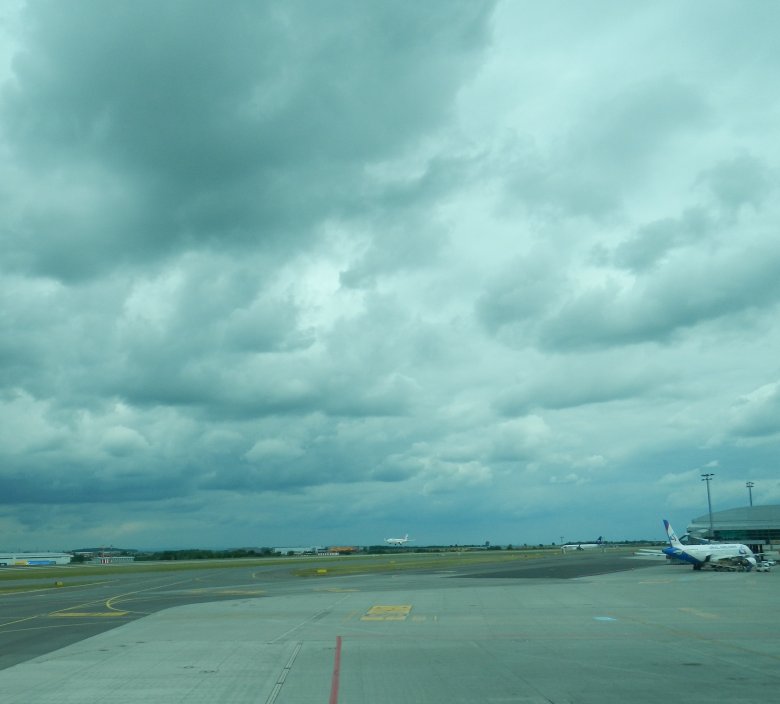 Watching landing airplanes while awaiting for mine to depart