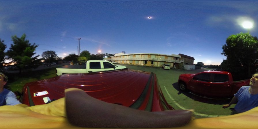 Selfie with the eclipsed sun. Sun is the small hollow light, the bigger lights are the street lamps that went on because of the darkness caused by the moon shadow. There were even stars visible on the sky during the totality (but the one on this picture is most likely the planet Venus) (August 2017)