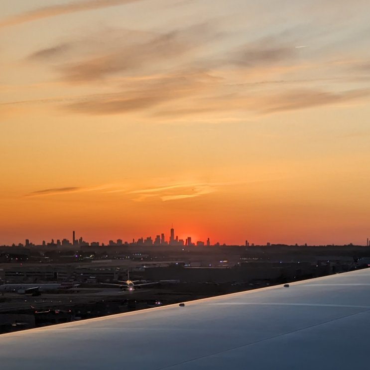 Landing in New York - beautiful sunset. Downtown Manhattan at the distance.