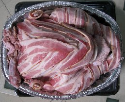 Almost 24 pounds of turkey covered with more than a pound of bacon right before its way to oven (November 2009)