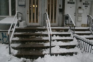 How our landlord cleaned his stairs - he's pushed the snow to our side that used to be clean before (February 2010)
