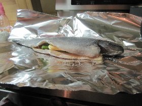 Katka is preparing trouts stuffed with herbs from our garden (likely the last such herbs this year) (December 2011)