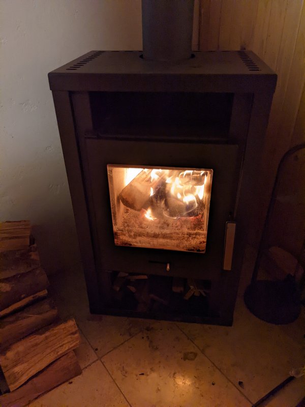 Then, in the evening, already at the cottage (obeying the quarantine), I am stoking the fireplace (January 2022)